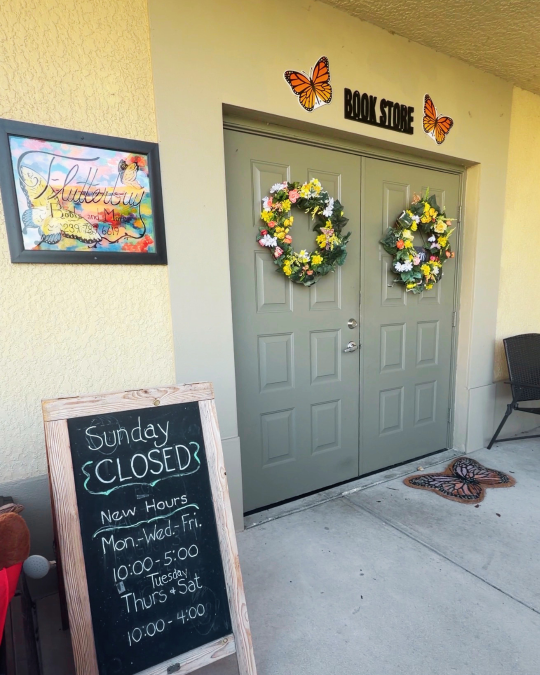 Flutterbuy Books and More entrance Cape Coral Florida bookstore green door with wreaths
